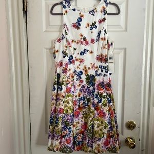 Maggie London - Party Dress.Tea length dress with slit pockets and under-ruffle.